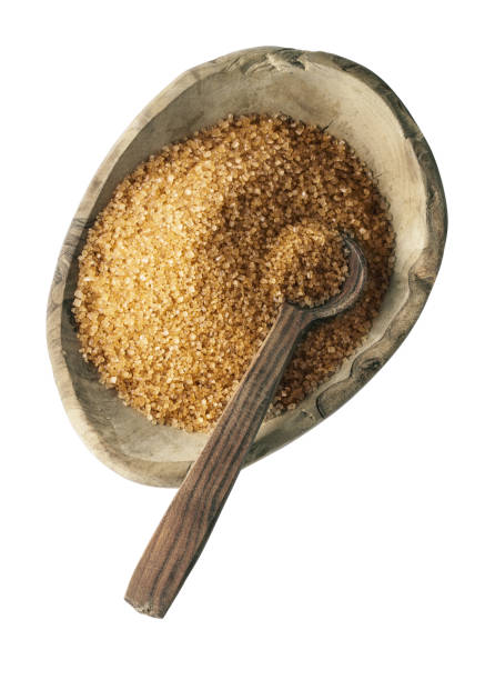 istock Brown sugar in wooden bowl with spoon isolated 1338940499