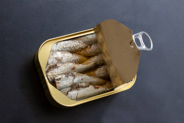 istock Open tin can of sardines with lid open. 1338941832