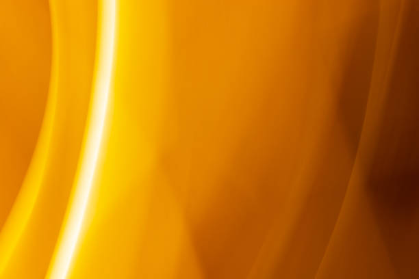 istock Abstract soft blurred golden background of rays, stripes and waves. 1338942042
