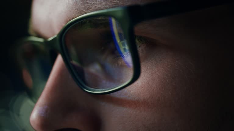 Super Close-up Portrait of Software Engineer Working on Computer, App Reflecting in Glasses. Digital Developer Working on Innovative e-Commerce Application with Machine Learning, AI, Big Data