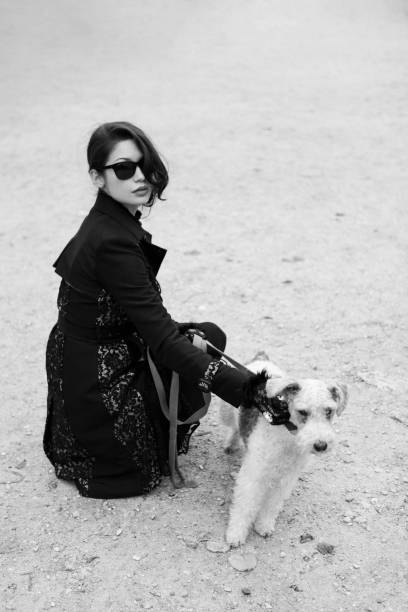 Woman with a dog in Tuileries in Paris, France.