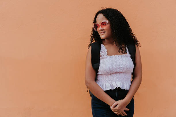 istock teenager carrying backpack while standing in front of wall 1338946478