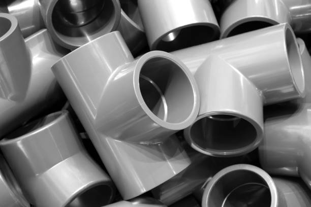 istock Grey pvc plumbing pipes corners background closeup 1338947646
