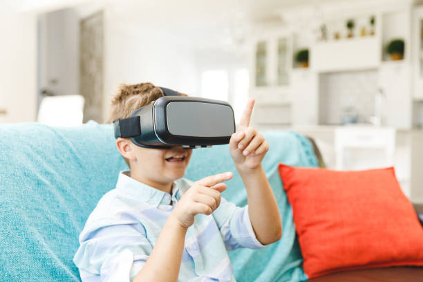 istock Caucasian boy sitting on couch and using vr headset in living room 1338948819