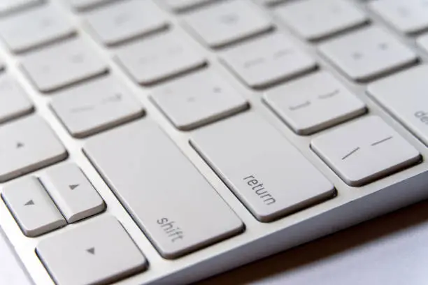 Photo of Close up view of Return Key in a White Keyboard