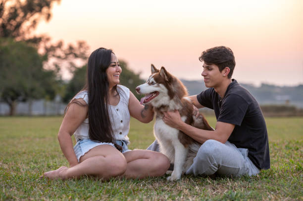 istock young couple with a dog at the park 1338954118