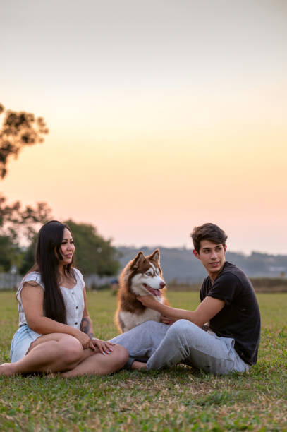 istock young couple with a dog at the park 1338954632