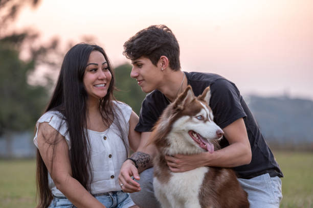 istock young couple with a dog at the park 1338954633