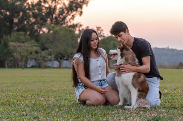 istock young couple with a dog at the park 1338954634