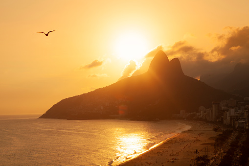 Sun setting behind the mountain from Ipanema Beach in Rio de Janeiro.