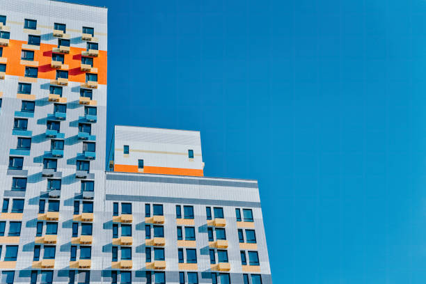 istock Apartment block with blue and orange windows 1338957193