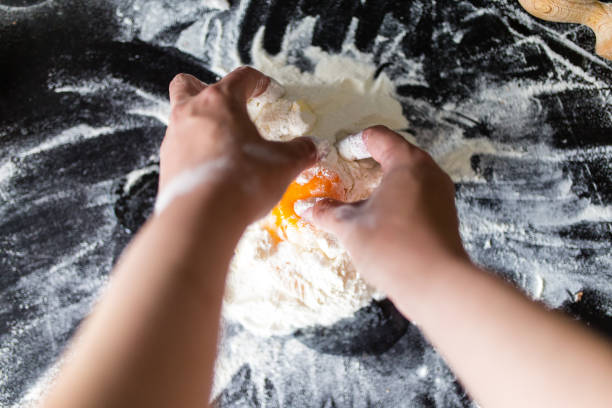istock Woman cooking dough 1338959086