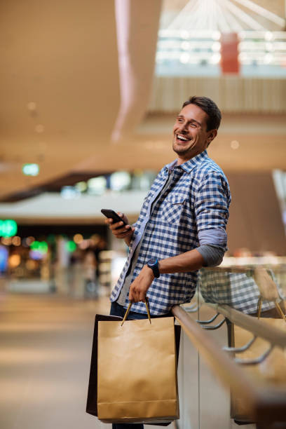 istock Happy man in shopping mall 1338959717