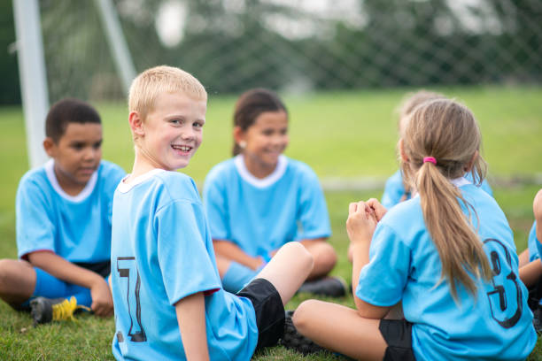 istock Little boy in soccer jersey smiling at the camera 1338965997