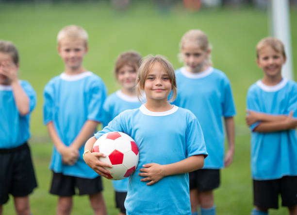 istock Smiling team captain from a children soccer team 1338966086