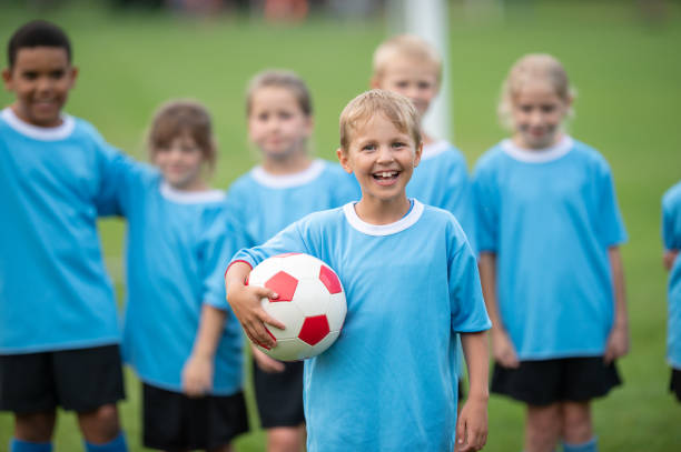 istock Smiling team captain from a children soccer team 1338966089