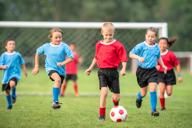 istock Elementary age children playing soccer outdoors 1338966095