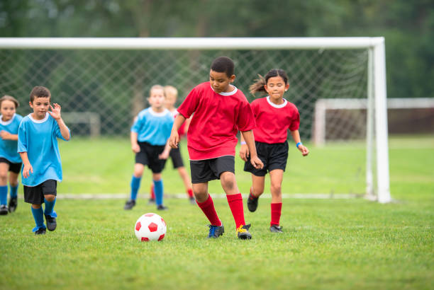 istock Multi ethnic children playing soccer together 1338966103