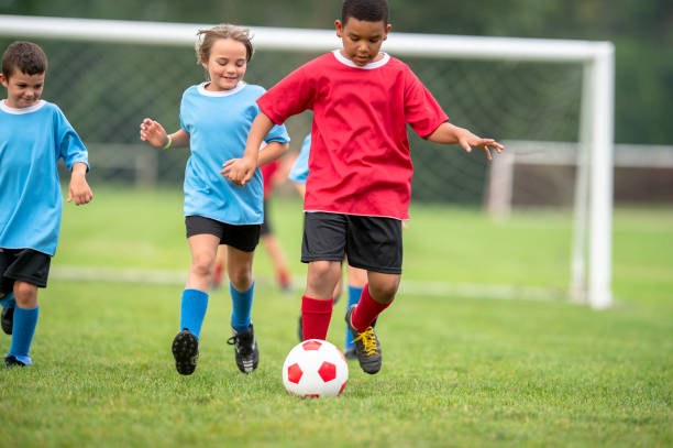 istock Children playing a friendly soccer match together 1338966106