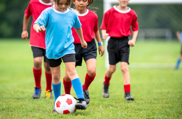 istock Children playing soccer at summer camp 1338966111