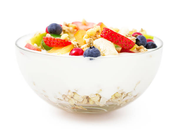 Bowl of yogurt, fresh fruit and muesli for healthy breakfast Healthy yogurt with fresh fruits and muesli isolated on white background. parfait photos stock pictures, royalty-free photos & images