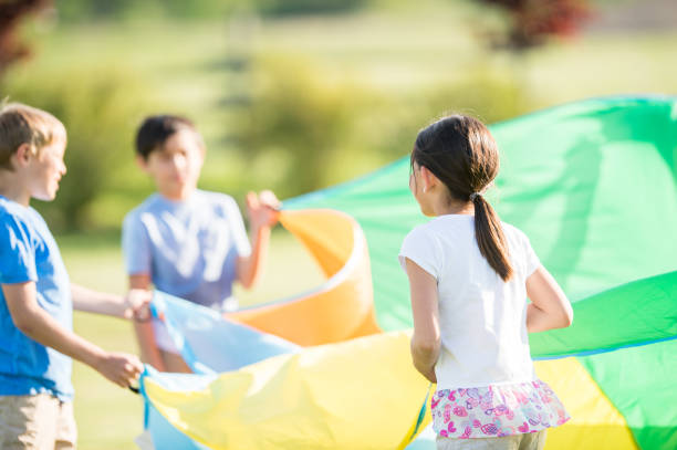 istock Children playing with playground parachute 1338966977