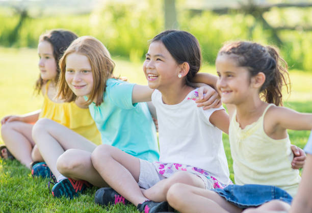 istock Little girls outdoors sitting at a park 1338966978