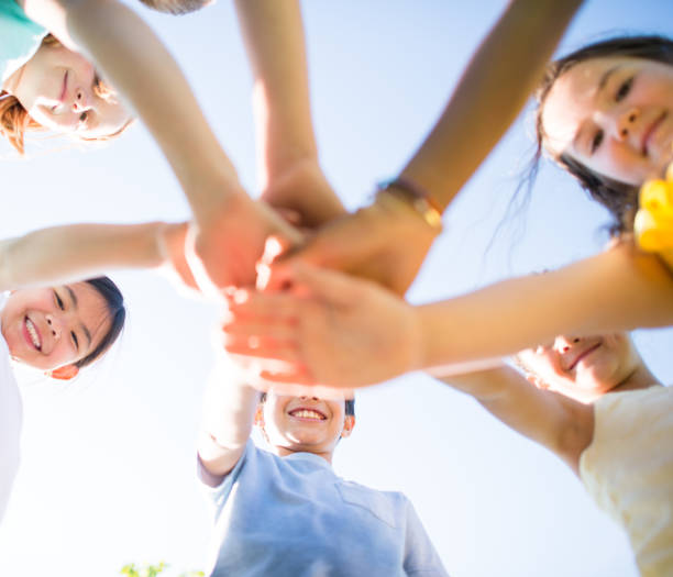 istock Diverse group of children with their hands together for a cheer 1338967006