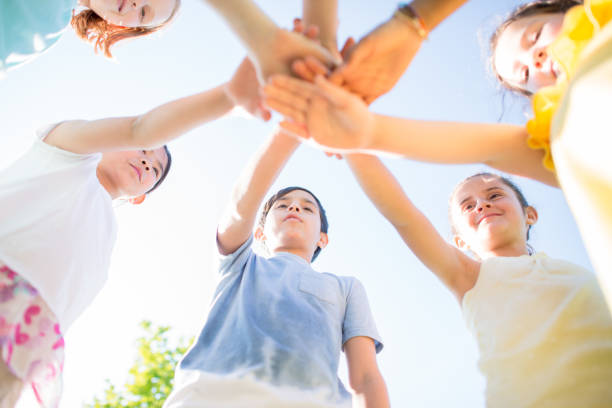 istock Children with their hands together for a group cheer 1338967010