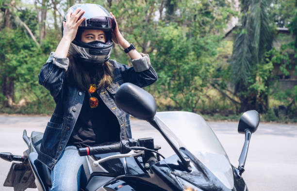 istock Confidence Asian woman wearing a motorcycle helmet before riding. 1338967731