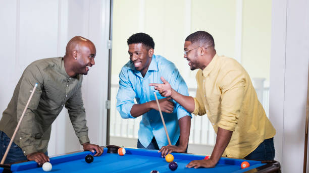 istock Three African-American men shooting pool, talking 1338970318