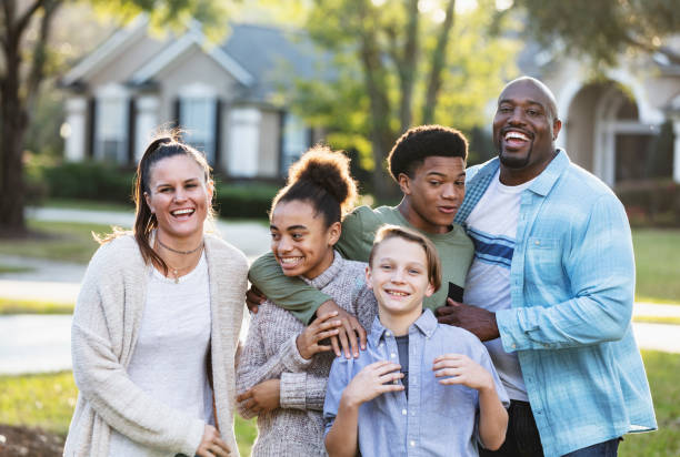 istock Blended multi-ethnic family, three children in front yard 1338970435