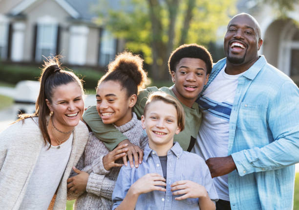 istock Blended multi-ethnic family, three children in front yard 1338970436