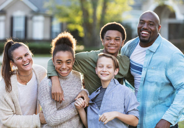 istock Blended multi-ethnic family, three children in front yard 1338970468