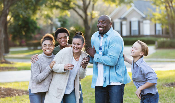 istock Blended multi-ethnic family of five laughing in yard 1338970492