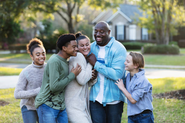 istock Blended multi-ethnic family of five laughing in yard 1338970497