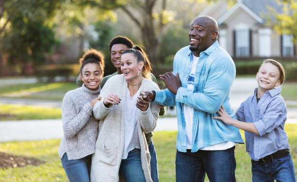 istock Blended multi-ethnic family of five laughing in yard 1338970498