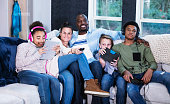 Blended multi-ethnic family on couch getting screen time