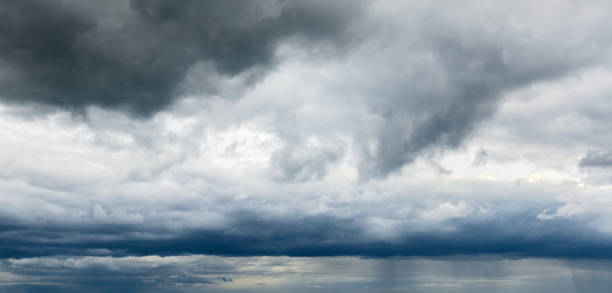 istock Stormy cloudy sky wide panorama, dramatic dark blue thunderclouds, gale cloudscape, gray cumulus rain clouds panoramic view, thunderstorm heaven landscape, overcast cloudiness weather, hurricane skies 1338971189