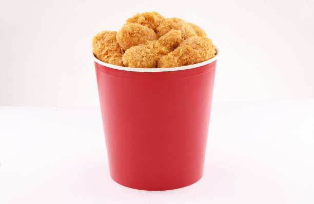istock breaded fried chicken legs bucket isolated on white background 1338972283