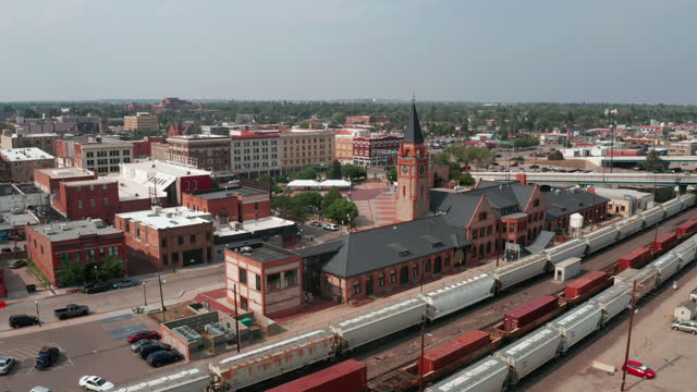 Aerial footage moving past the Train Depot with downtown Cheyenne in the background