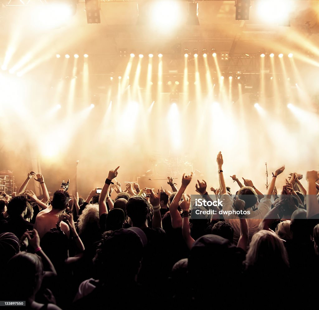 Concert crowd in front of stage lighting effects Concert Crowd in motion Fame Stock Photo