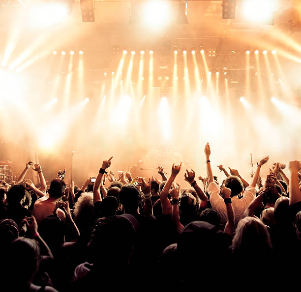 Concert crowd in front of stage lighting effects stock photo