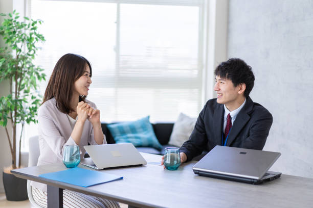 istock Man and woman talking happily in an office 1338975878