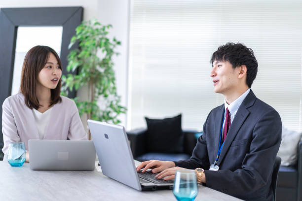 istock Man and woman talking happily in an office 1338975899