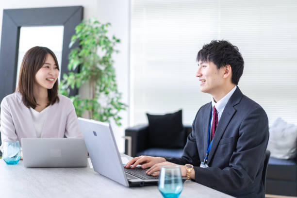istock Man and woman talking happily in an office 1338975900