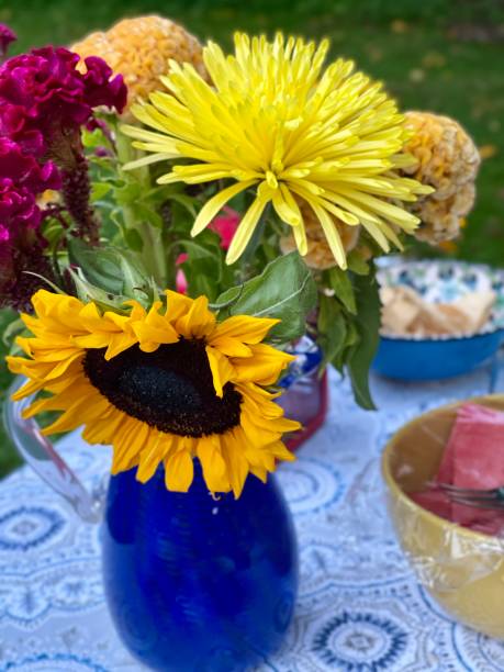 istock Flowers on a table outside with food 1338977712
