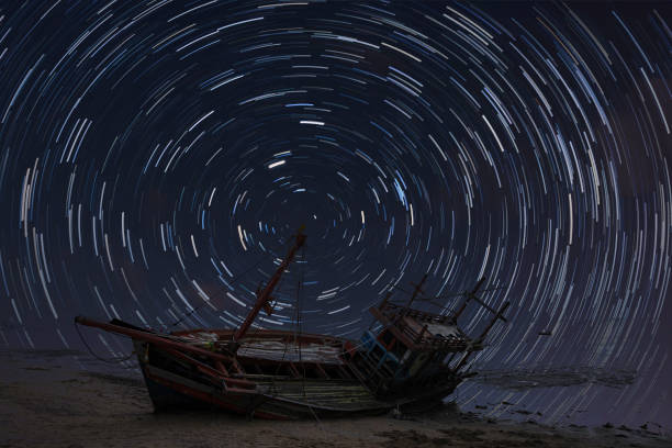 istock Rotating stars and abandoned ships,Exposure image showing star trails over shipwreck 1338978013