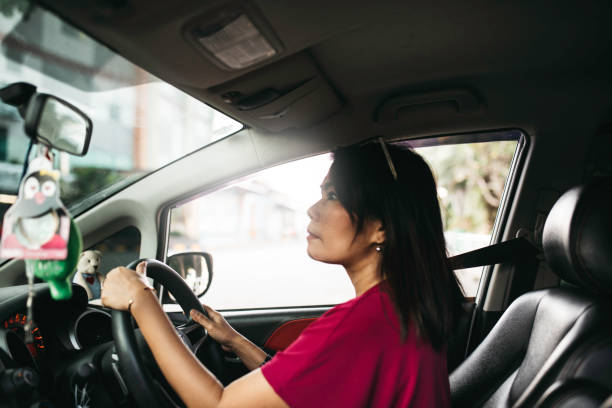 istock asian woman driving car 1338983232