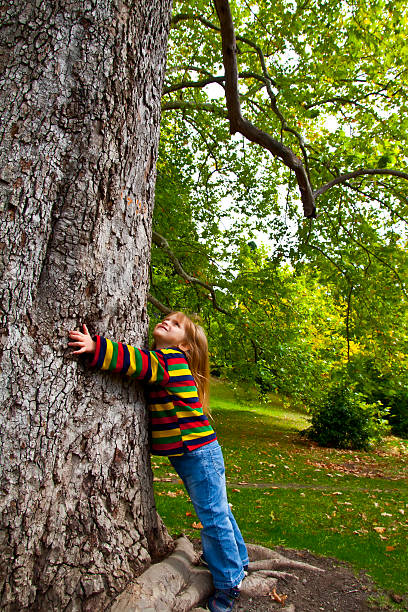 istock Small girl standing near ancient big tree. Protect environment concept. 133898377